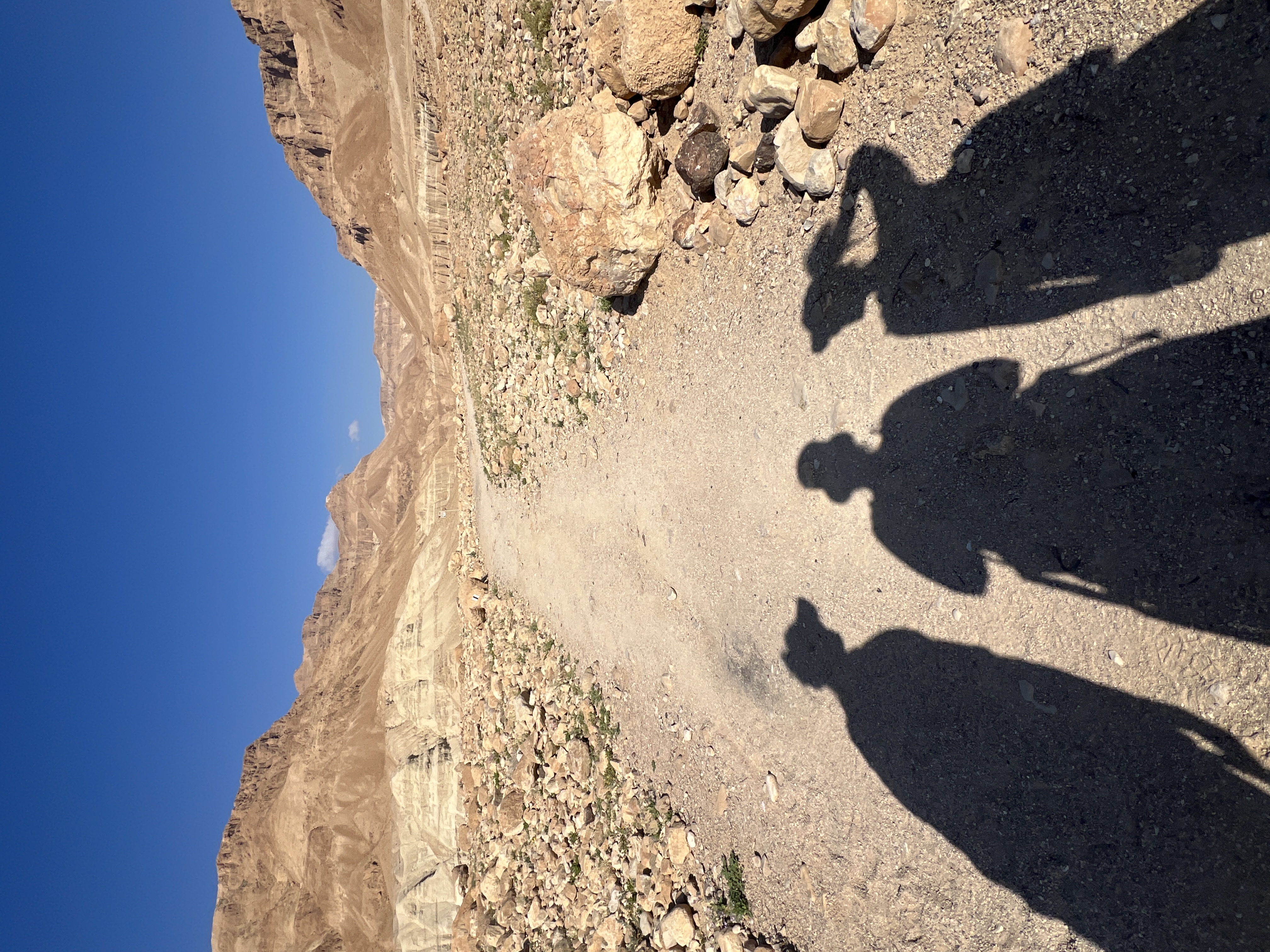 Three shadows cast on desert ground, Nahal Tze'elim hike, Dead Sea