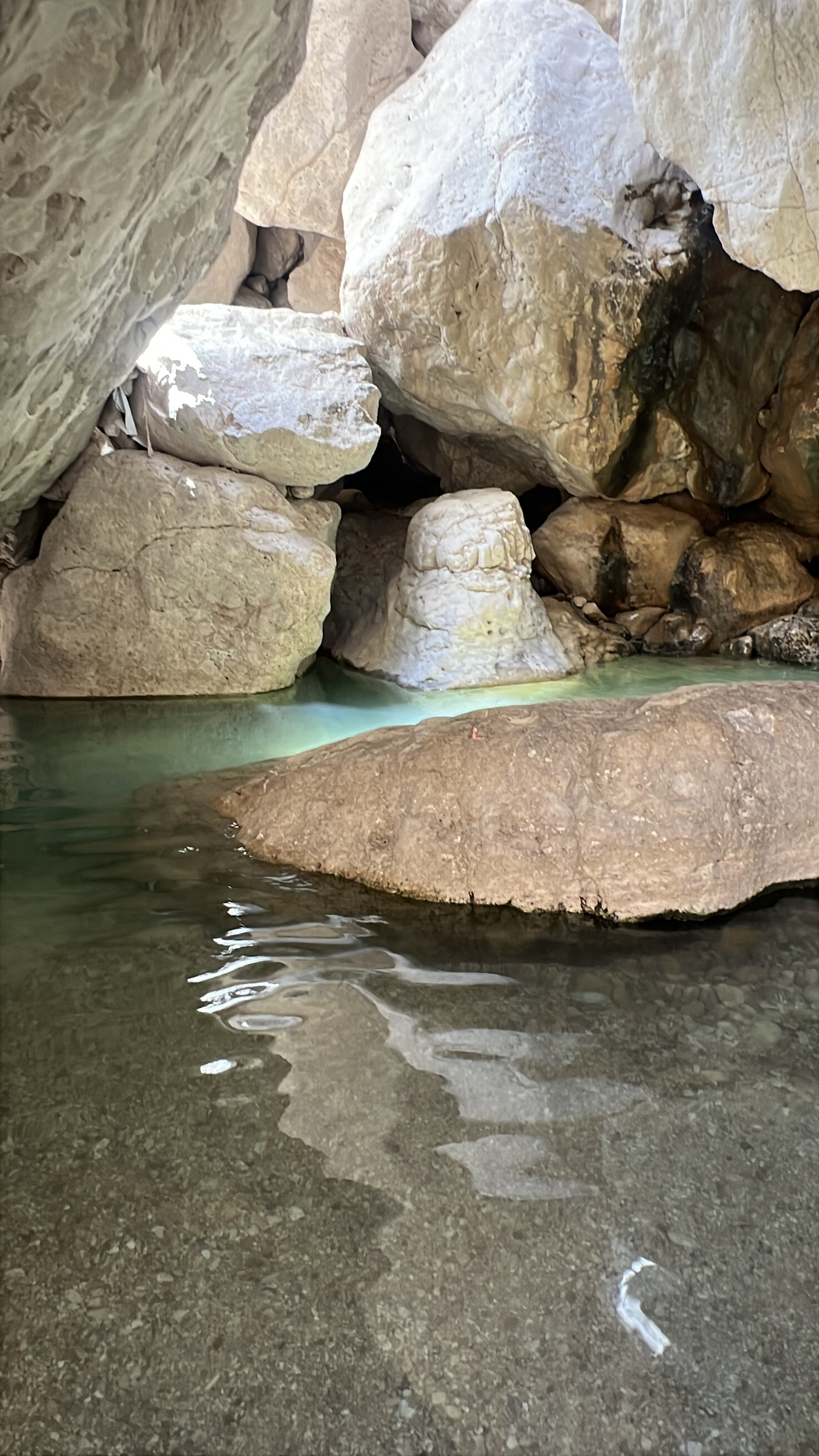 Turquoise natural pool between large boulders, Ein Namer, Nahal Tze'elim