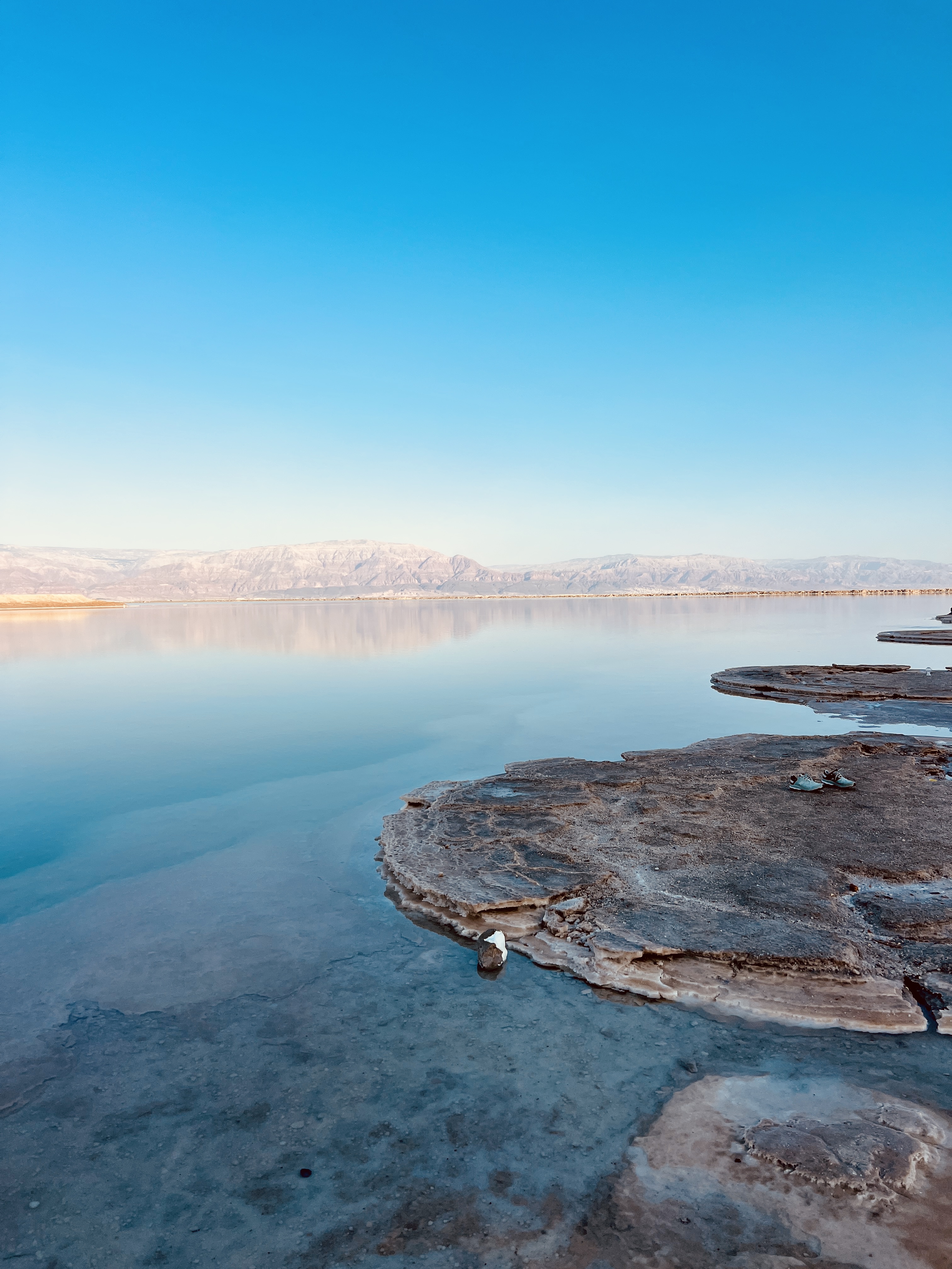 Dead Sea at golden hour, salt formations and still water